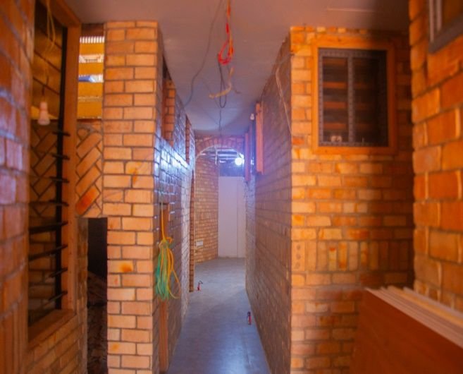 A brick hallway at Dzidzor (Joy) Hostel